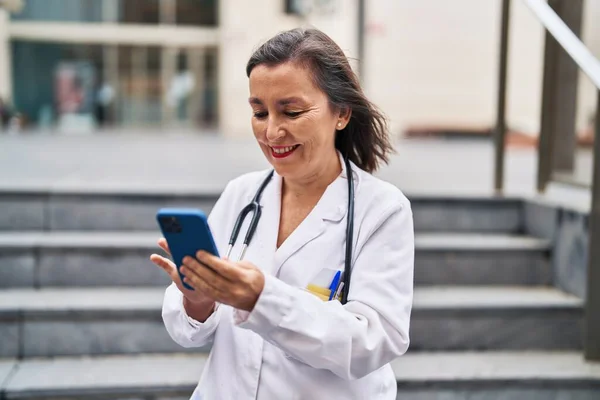 Middle Age Woman Wearing Doctor Uniform Using Smartphone Street — Stockfoto