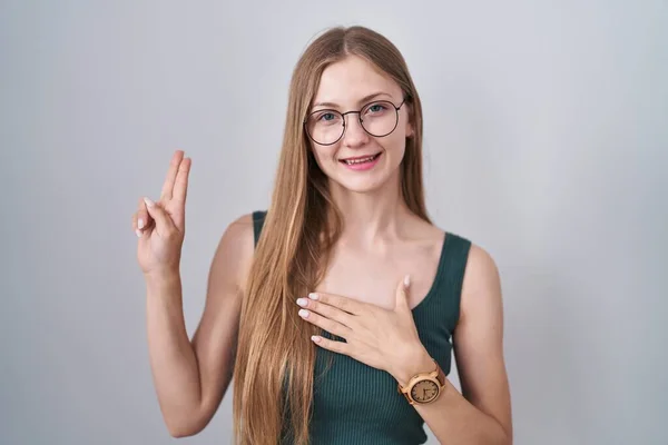Young Caucasian Woman Standing White Background Smiling Swearing Hand Chest — Stock Photo, Image