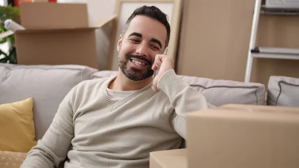 Young Hispanic Man Smiling Confident Talking Smartphone New Home — Stockfoto