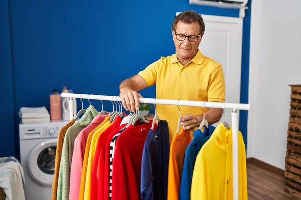 Middle Age Man Smiling Confident Leaning Clothes Rack Laundry Room — Fotografia de Stock