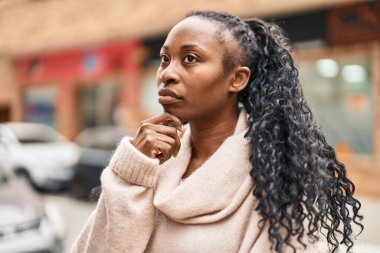 African american woman standing with doubt expression at street