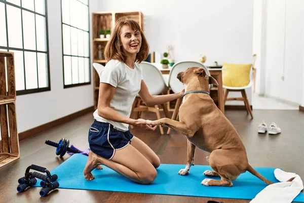 Νεαρή Καυκάσια Αθλήτρια Γυναίκα Χαμογελά Αυτοπεποίθηση Παίζοντας Σκυλί Στο Σπίτι — Φωτογραφία Αρχείου