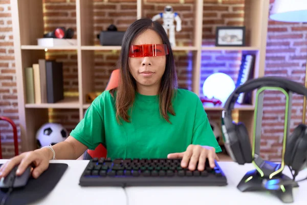 stock image Middle age chinese woman wearing virtual reality glasses skeptic and nervous, frowning upset because of problem. negative person. 