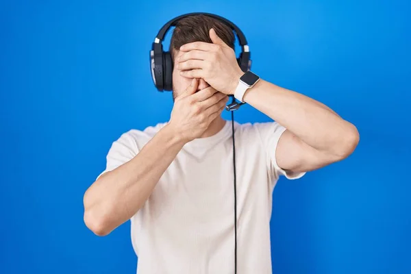 Іспанець Бородою Слухає Музику Навушниках Закриваючи Очі Рот Руками Здивований — стокове фото