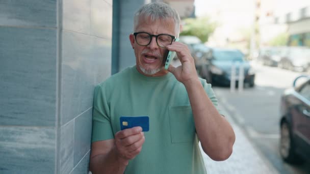 Orta Yaşlı Kır Saçlı Bir Adam Akıllı Telefon Kredi Kartıyla — Stok video