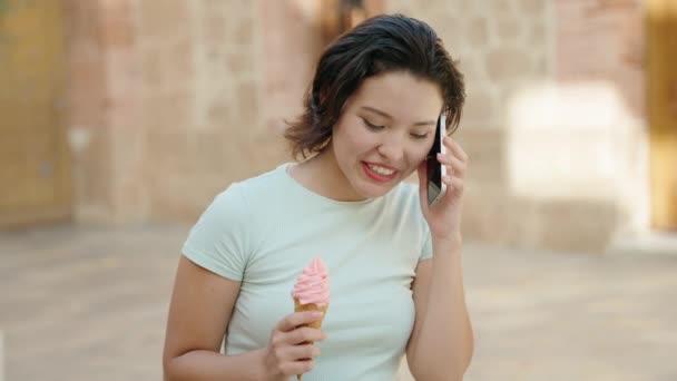 Mujer Hispana Joven Hablando Teléfono Inteligente Comiendo Helado Calle — Vídeo de stock