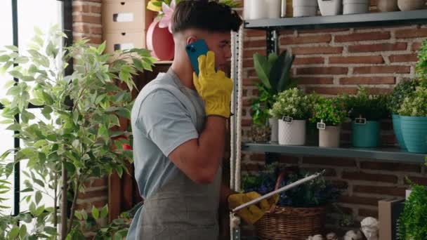 Young Hispanic Man Florist Talking Smartphone Reading Clipboard Flower Shop — Stock Video