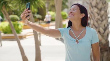 Genç, güzel, İspanyol bir kadın gülümsüyor.