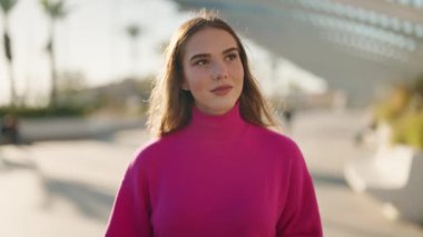 Young blonde woman smiling confident using professional camera at street