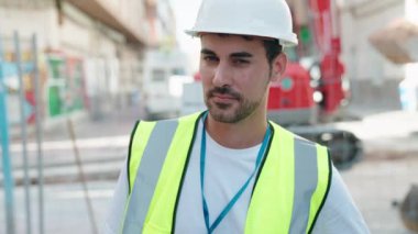 Young hispanic man architect smiling confident standing at street