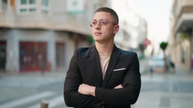 Young hispanic man executive smiling confident standing with arms crossed gesture at street