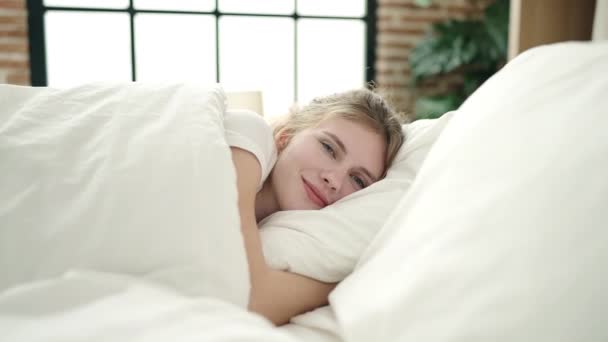 Junge Blonde Frau Lächelt Selbstbewusst Auf Bett Schlafzimmer Liegend — Stockvideo
