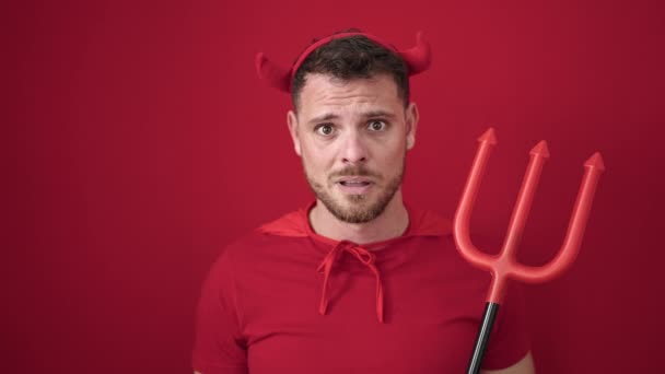 Young Caucasian Man Looking Afraid Wearing Devil Costume Isolated Red — Stock videók