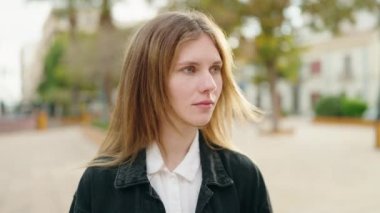 Young caucasian woman smiling confident standing at park