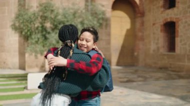 African american mother and son smiling confident hugging each other at park