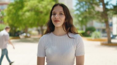 Young woman smiling confident pointing with fingers at park