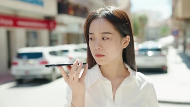Young Chinese Woman Talking Smartphone Serious Expression Street — Stockvideo
