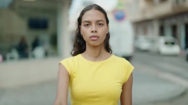 Young african american woman doing stop gesture with hand at street