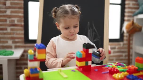 Adorable Hispanic Girl Playing Construction Blocks Standing Kindergarten — Vídeo de stock