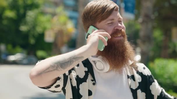Ung Rödhårig Man Ler Säker Talar Smartphone Parken — Stockvideo