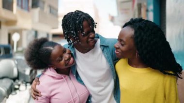 African american friends smiling confident hugging each other at street