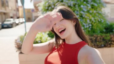 Young caucasian woman smiling confident having video call at street