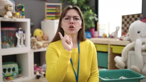 Young Blonde Woman Preschool Teacher Asking Silence Kindergarten — Stok Video