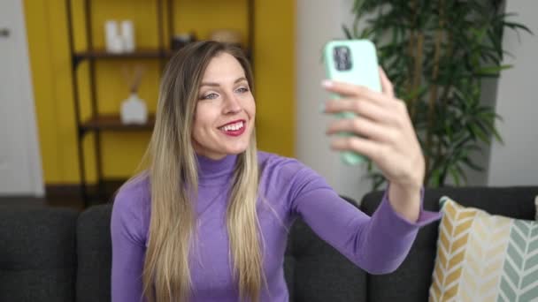 Sarışın Genç Bir Kadın Evdeki Koltukta Video Görüşmesi Yapıyor — Stok video