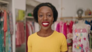 African american woman customer holding shopping bags having video call at clothing store