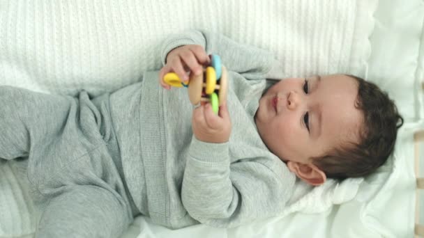 Adorable Hispanic Baby Lying Bed Playing Toy Bedroom — Stock Video