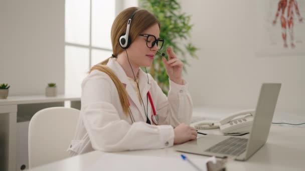 Young Blonde Woman Wearing Doctor Uniform Having Teleconsultation Clinic — Stockvideo