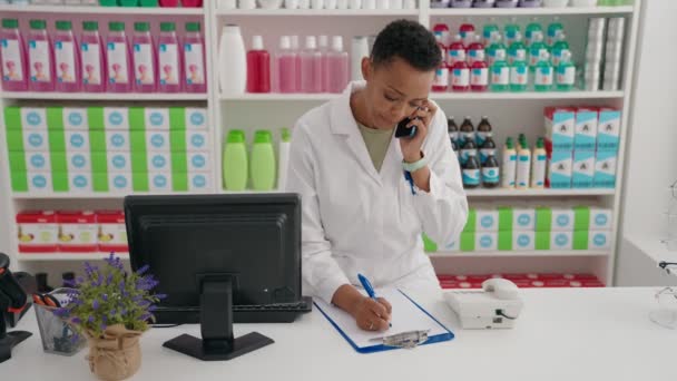 African American Woman Pharmacist Talking Smartphone Writing Document Pharmacy — Stok Video