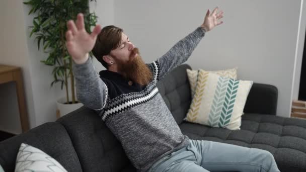 Young Redhead Man Relaxed Hands Head Sitting Sofa Home — Vídeo de Stock