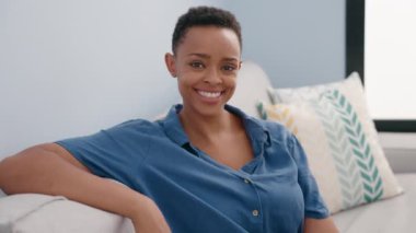 African american woman smiling confident sitting on sofa at home