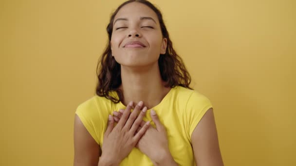 Молода Афроамериканська Жінка Яка Впевнено Посміхається Поклавши Руки Жовте Тло — стокове відео