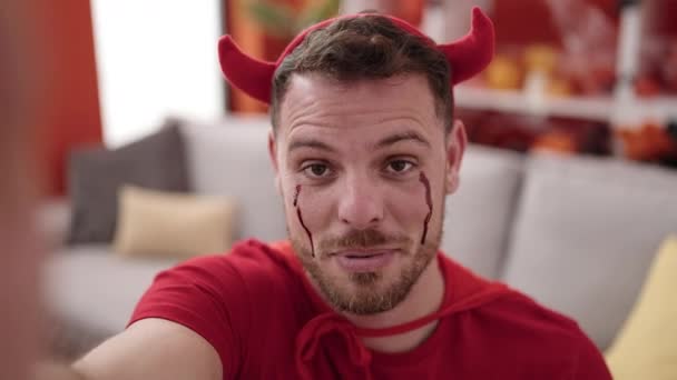 Young Caucasian Man Wearing Devil Costume Taking Selfie Picture Home — Video