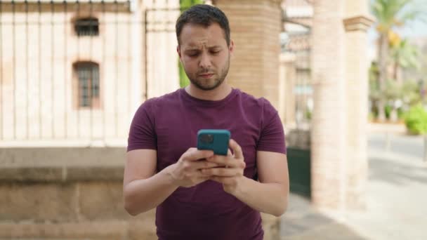 Young Man Using Smartphone Street — стоковое видео