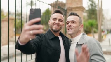 Young couple smiling confident having video call at street