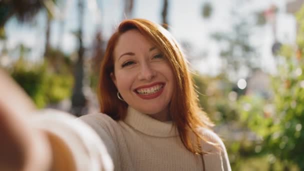 Joven Pelirroja Sonriendo Confiada Teniendo Videollamada Parque — Vídeos de Stock