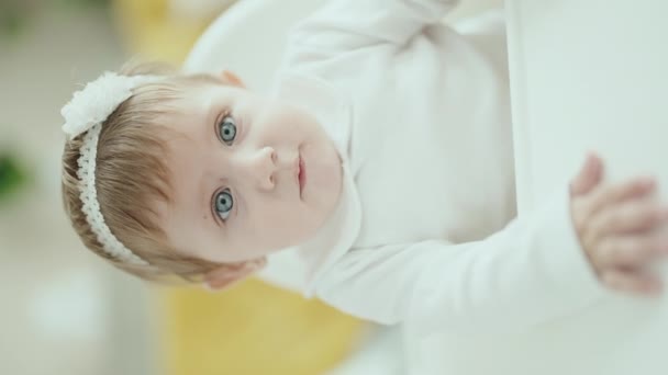 Adorable Blonde Baby Sitting Highchair Relaxed Expression Home — Stockvideo