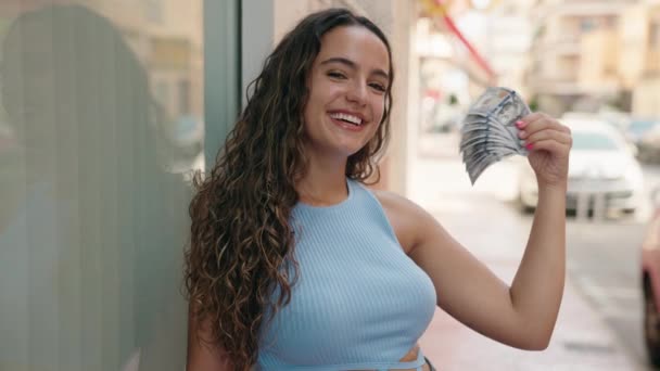 Young Beautiful Hispanic Woman Smiling Confident Using Dollars Handfan Street — Stockvideo