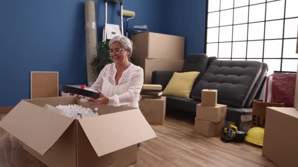 Middle Age Grey Haired Woman Smiling Confident Unboxing Package New — ストック動画