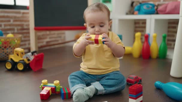 Adorable Hispanic Baby Playing Construction Blocks Sitting Floor Kindergarten — ストック動画
