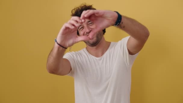 Young Hispanic Man Smiling Confident Doing Heart Gesture Hands Isolated — 비디오