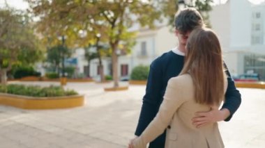 Young couple smiling confident dancing at park