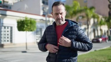 Middle age man suffering heart attack at street