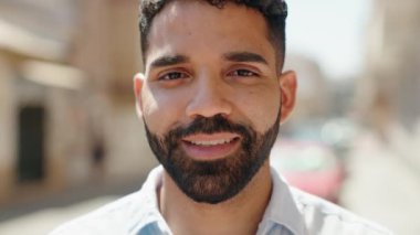 Young arab man smiling confident standing at street