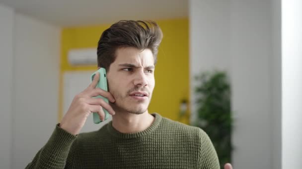 Young Hispanic Man Talking Smartphone Unhappy Expression Home — Vídeo de stock
