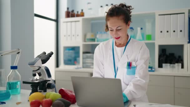 Middle Age Woman Wearing Scientist Uniform Using Laptop Laboratory — Wideo stockowe