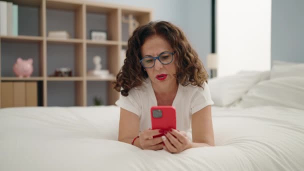 Middelbare Leeftijd Vrouw Ongelukkig Met Behulp Van Smartphone Liggen Bed — Stockvideo